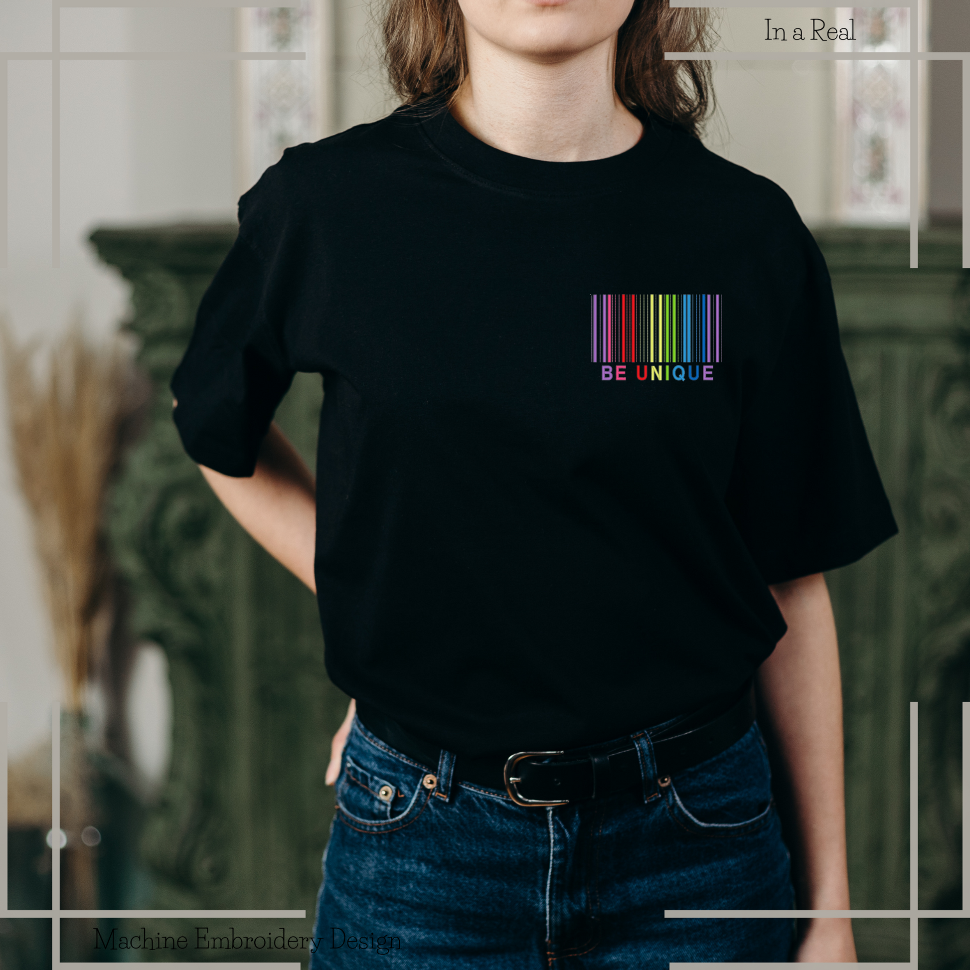 Embroidery design featuring a rainbow barcode with the phrase 'Be unique' below, displayed on a t-shirt