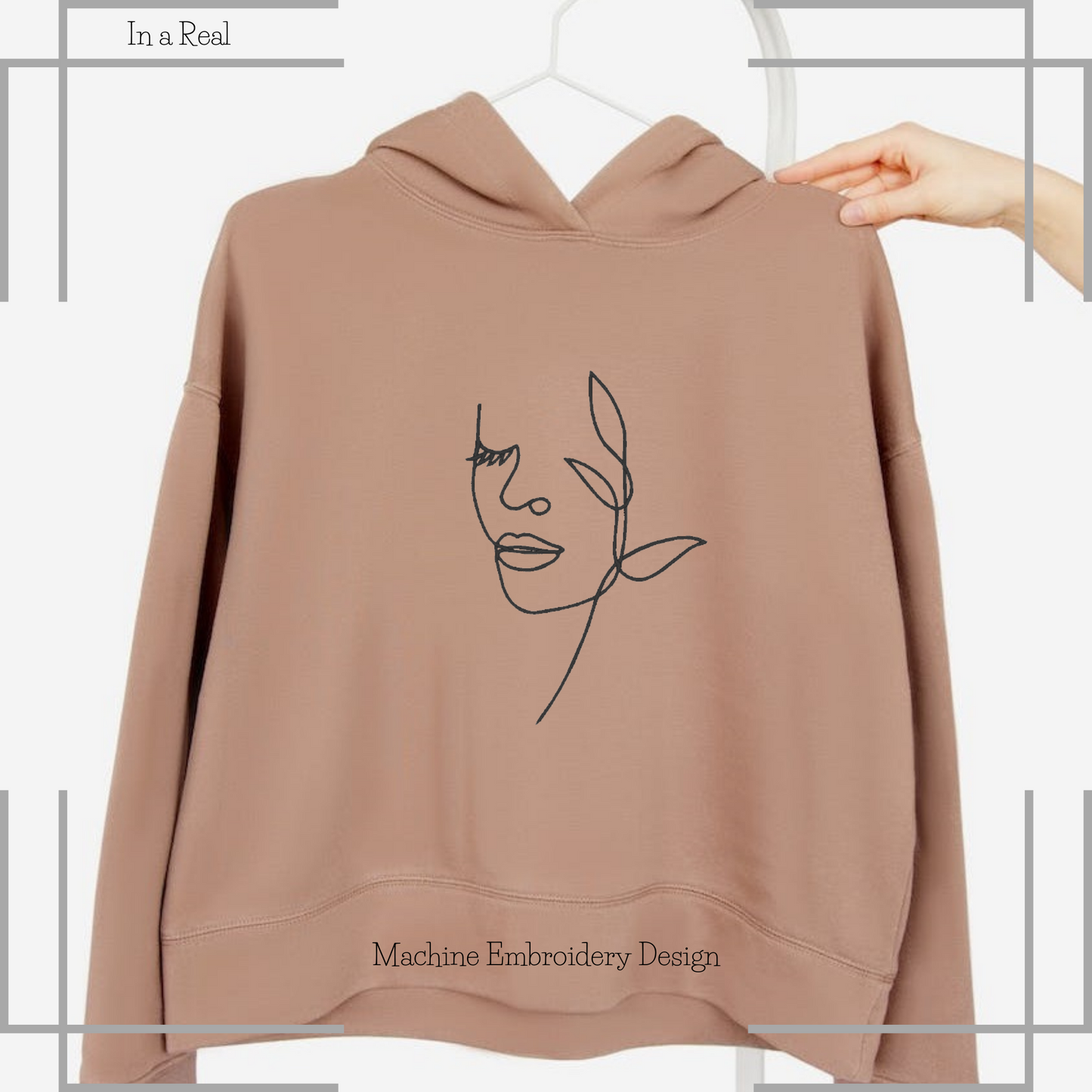 Woman face by flower line art machine embroidery design is displayed on a hoodie 