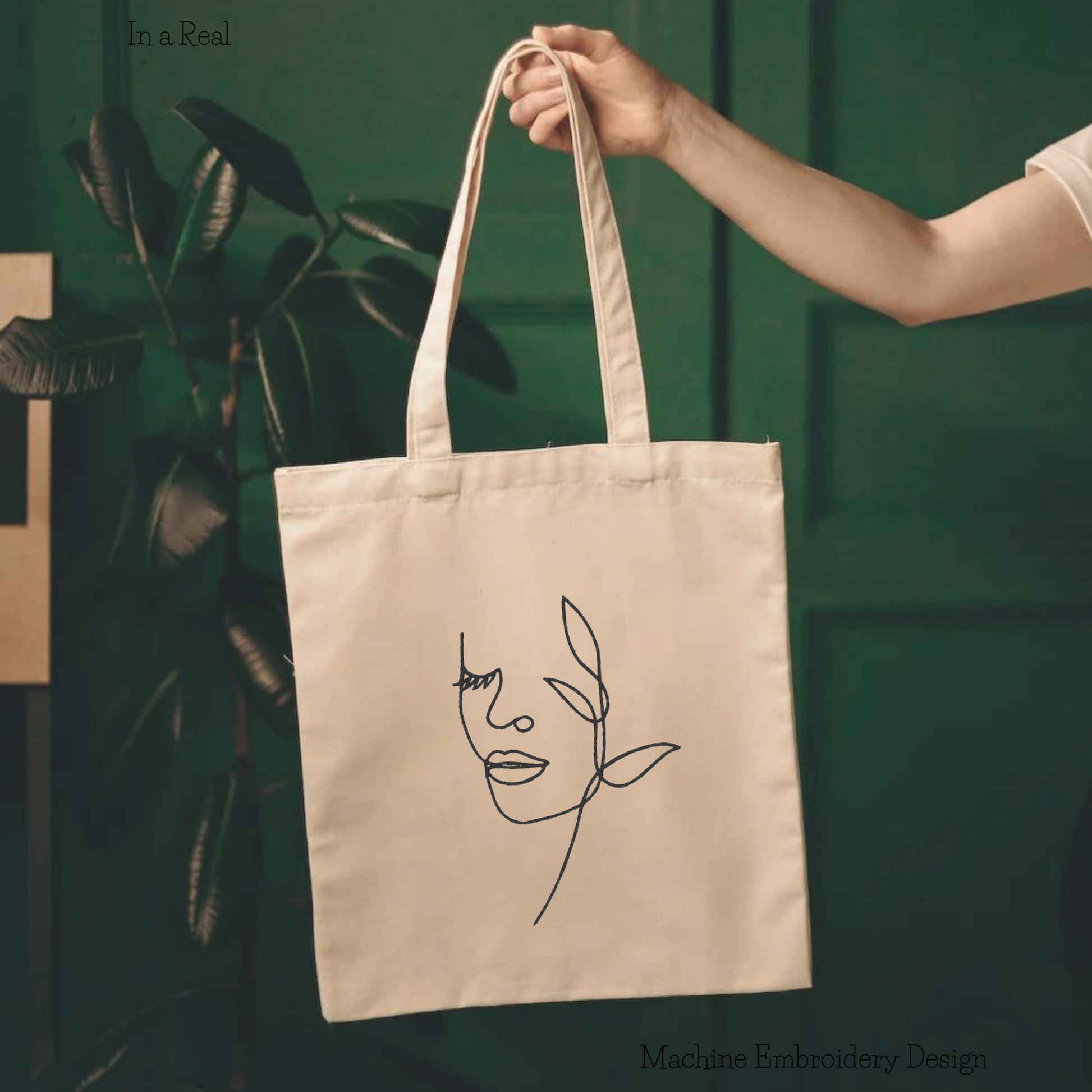 Woman face by flower line art machine embroidery design is displayed on a tote bag