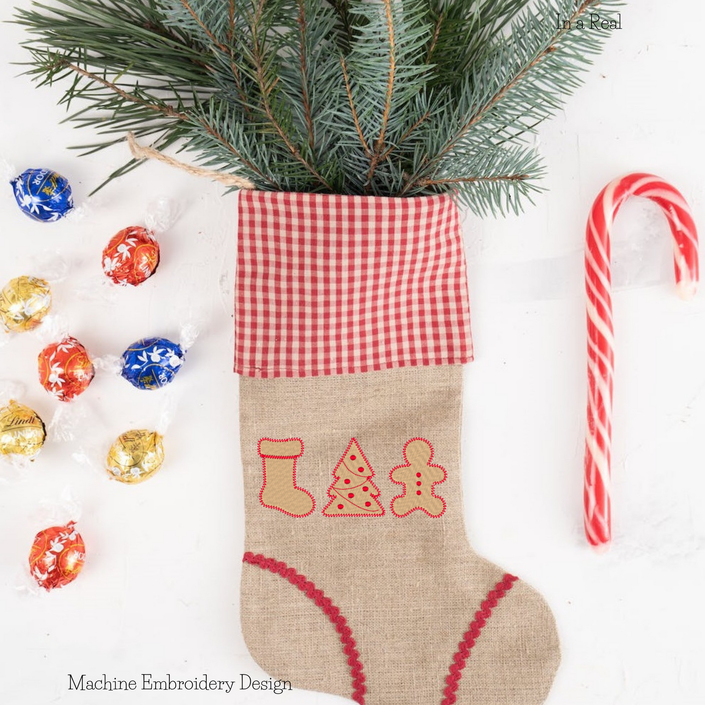 Christmas Cookie Trio machine embroidery design featuring a decorated Christmas tree, a festive stocking, and a gingerbread cookie is displayed on a Christmas Stocking