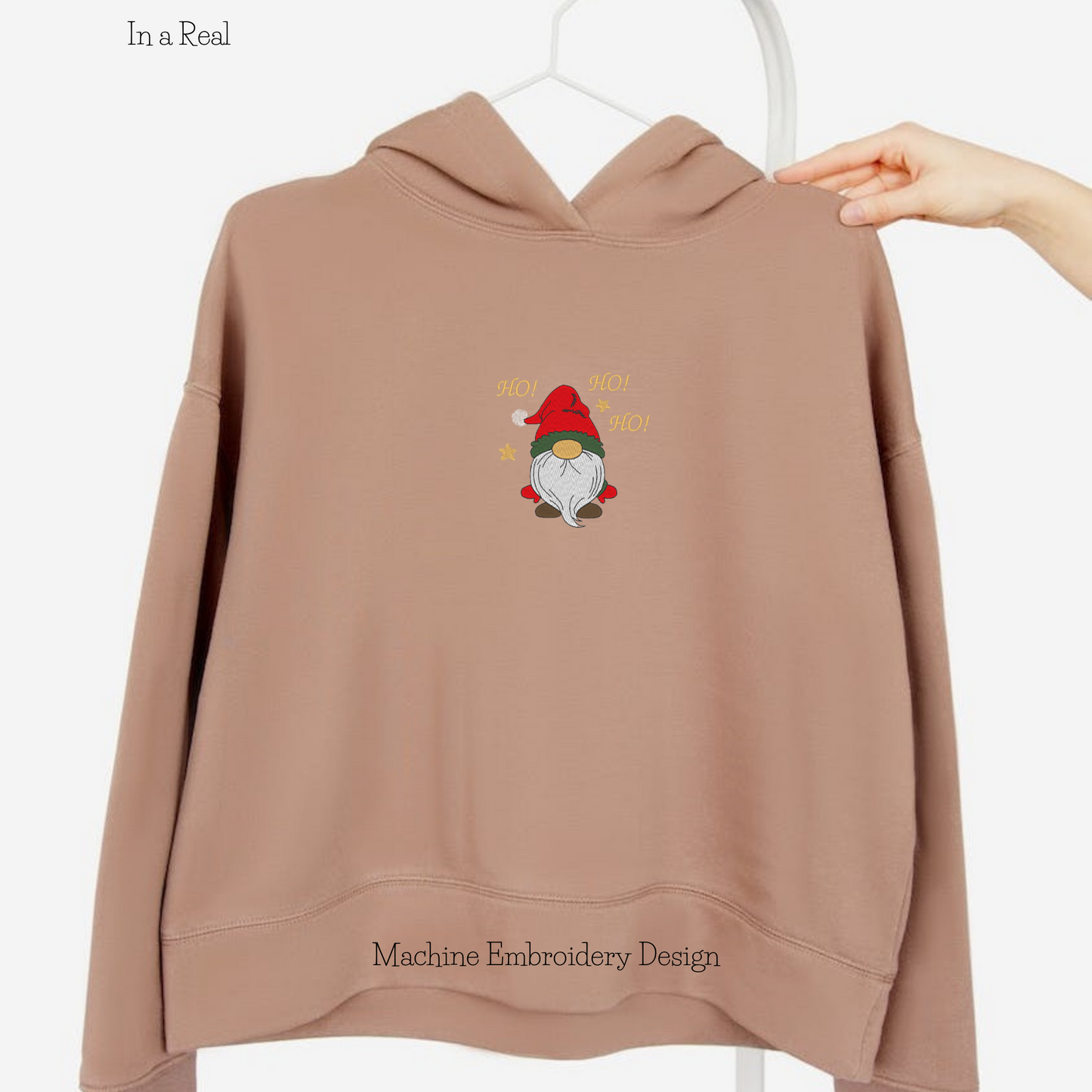 Machine embroidery design of Christmas gnome with the exclamation "Ho! Ho!Ho!" is  displayed on a hoodie