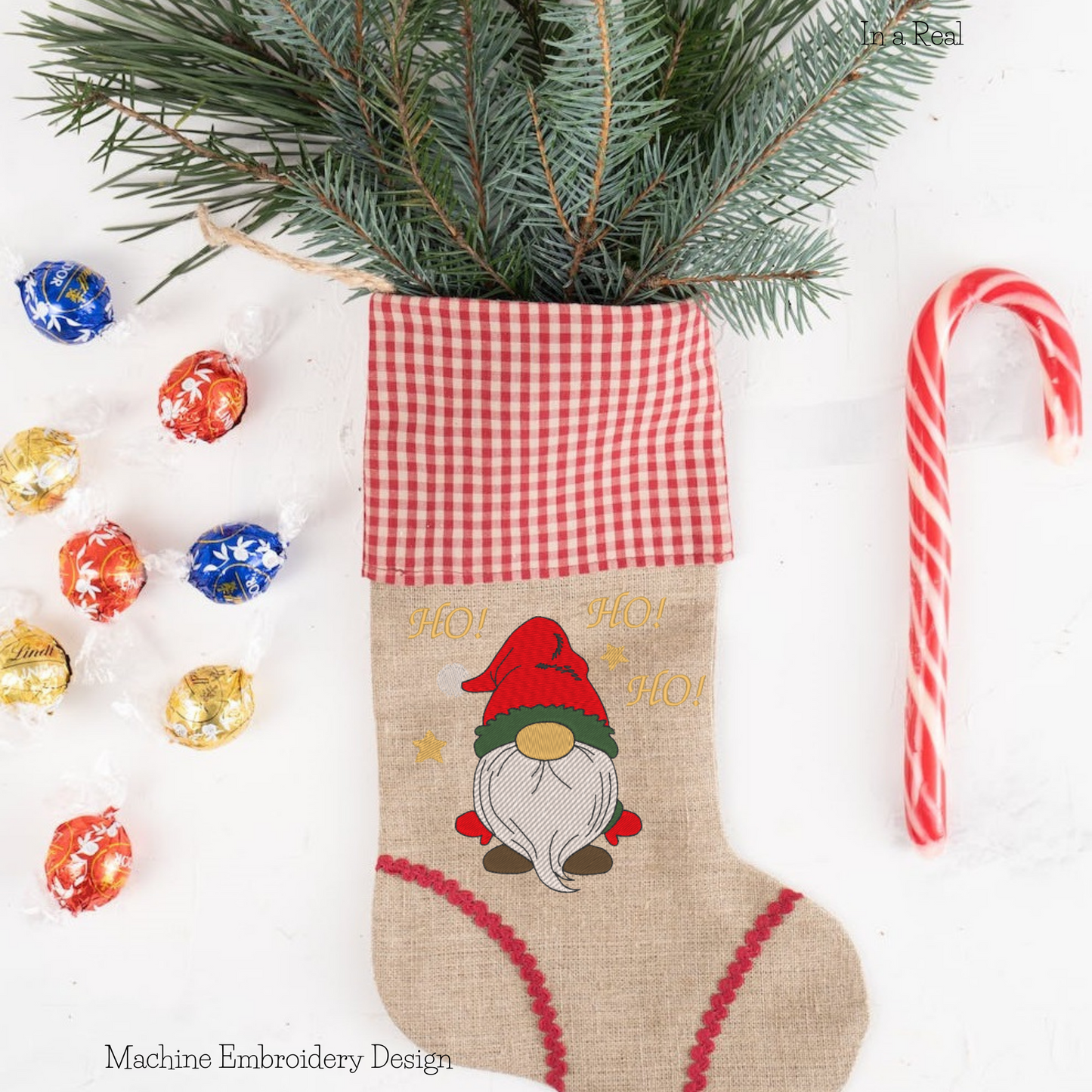 Machine embroidery design of Christmas gnome with the exclamation "Ho! Ho!Ho!" is  displayed on a Christmas Stocking