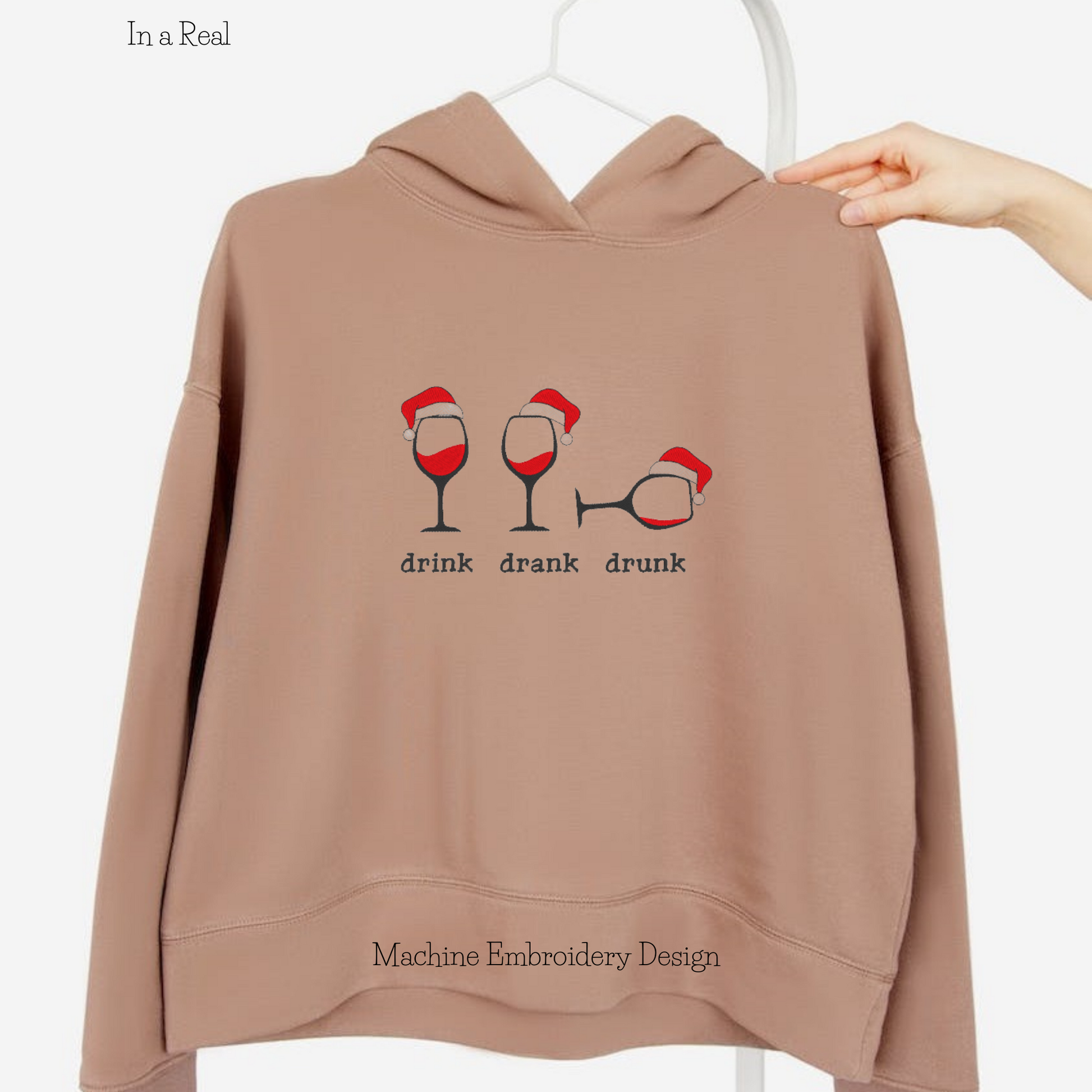 A machine embroidery design featuring three wine glasses wearing Santa's hats, with the words "Drink, Drank, Drunk" embroidered below them is displayed on a hoodie