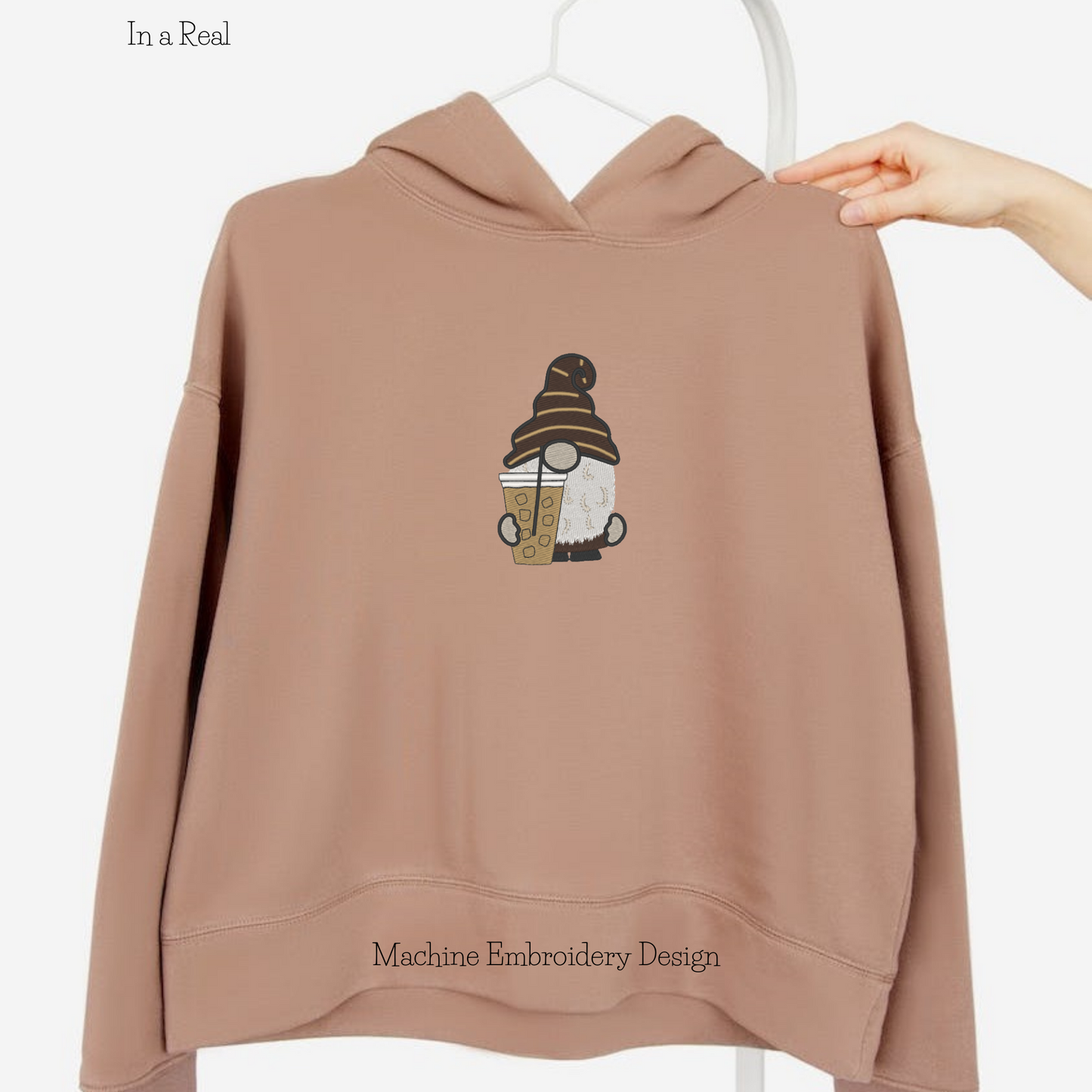 Machine embroidery design: An adorable gnome enjoying iced coffee is displayed on a hoodie