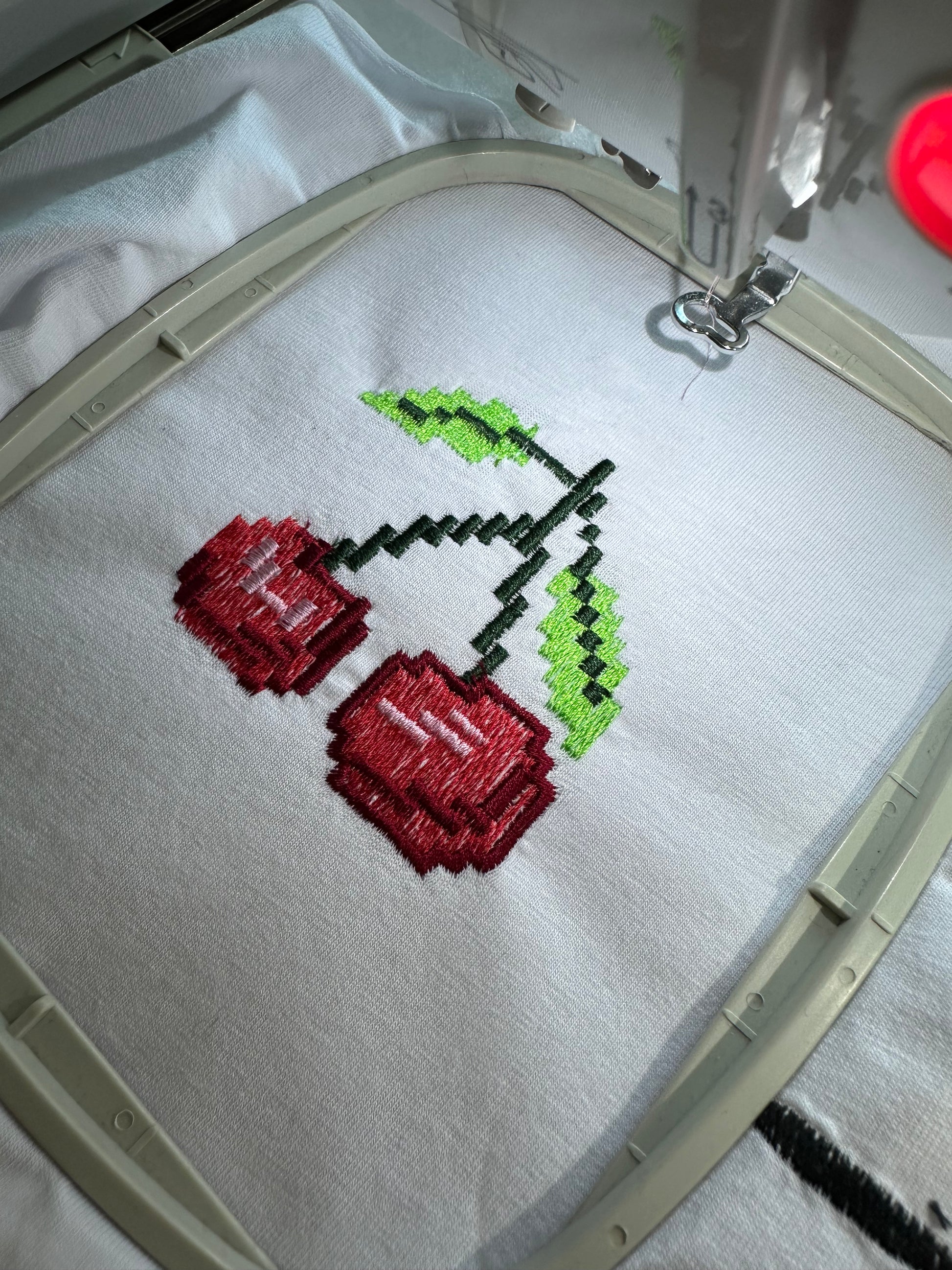 Pixel Cherry embroidery design, ideal for creating fun, vibrant, and retro-inspired embroidery projects.