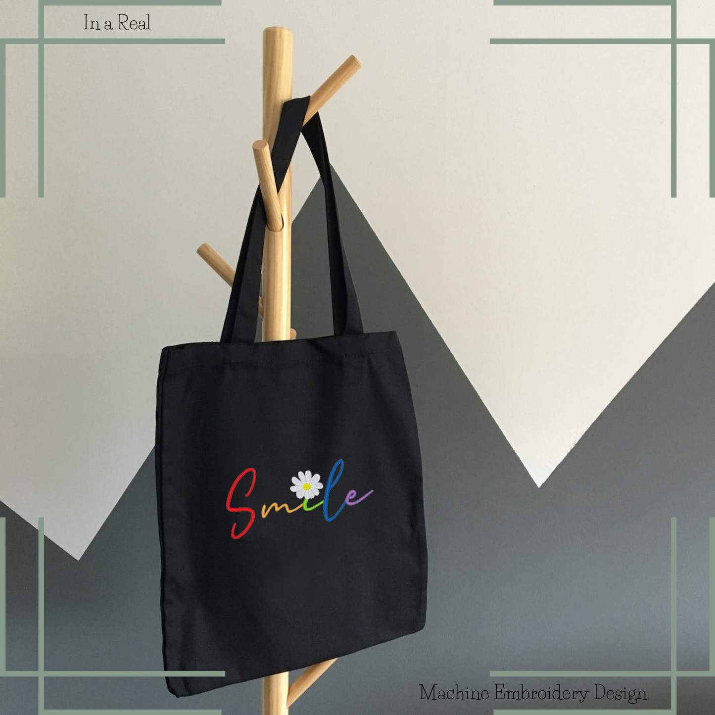 The Rainbow Smile Embroidery Design on a tote bag showcases the word 'Smile' in colorful letters, with a chamomile flower replacing the dot in the 'i'