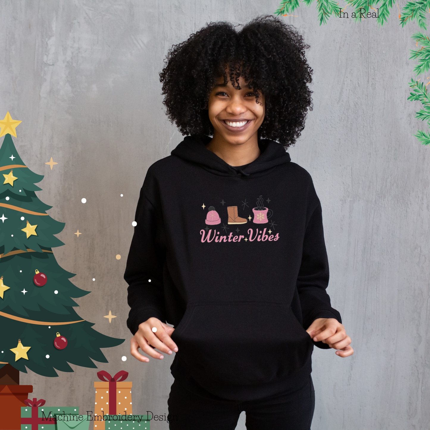 Winter Vibes' machine embroidery design, featuring a cozy knitted hat, snug Ugg boot, and hot cocoa with marshmallows, is displayed on a hoodie