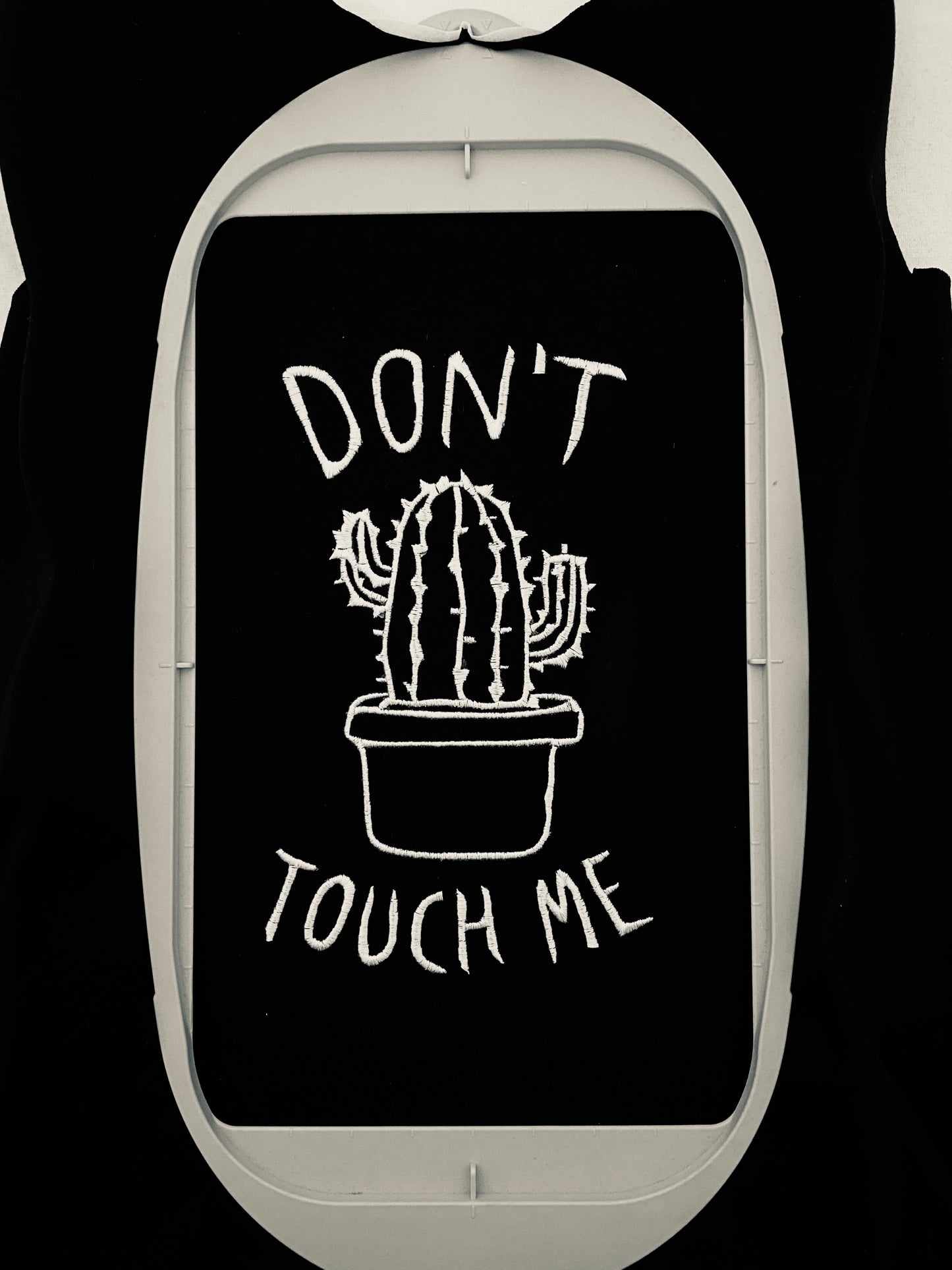 Machine embroidery design depicting a cactus in a pot with 'Don't touch me' text