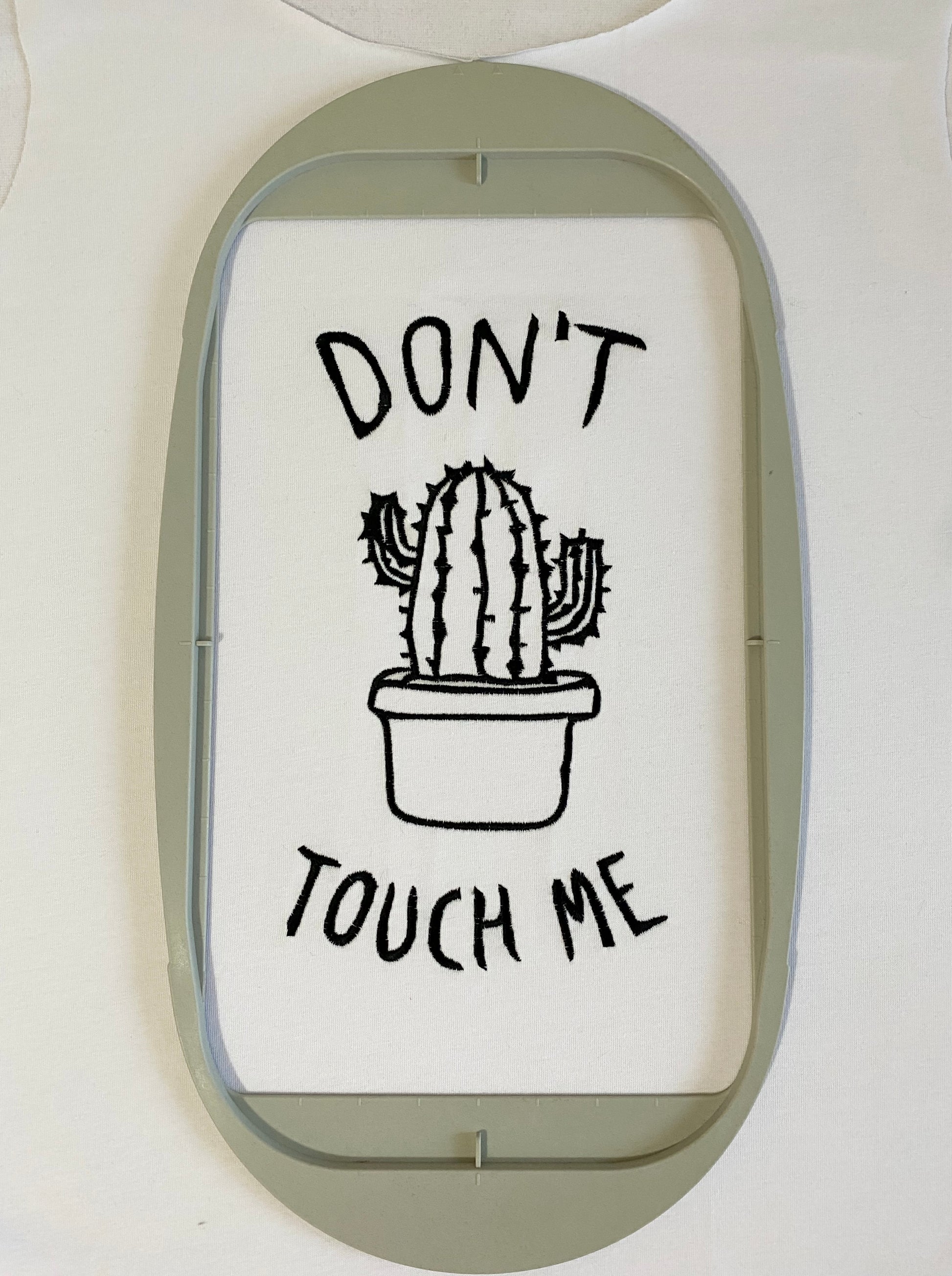 Machine embroidery design depicting a cactus in a pot with 'Don't touch me' text