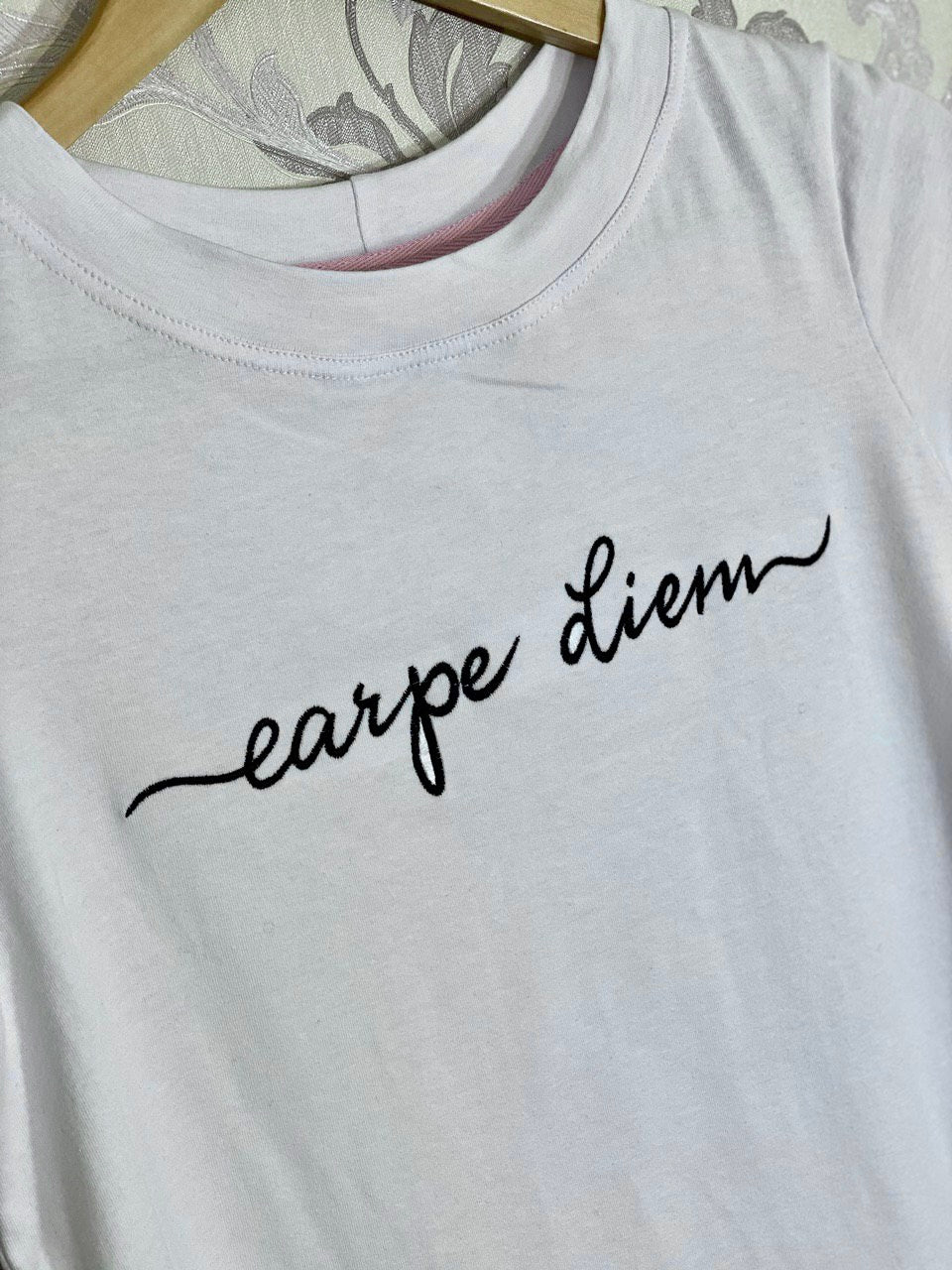 Stylish 'Carpe diem' embroidery design adorning a t-shirt