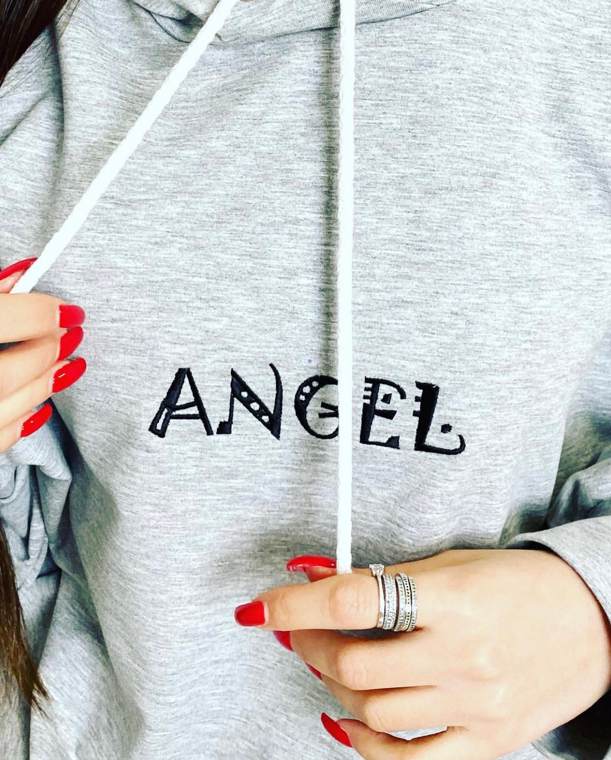 Unique capital letters machine embroidery design of 'ANGEL' beautifully displayed on a hoodie